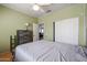 Bright bedroom featuring laminated wood floors, ceiling fan and a sliding closet at 238 W Marco Polo Rd, Phoenix, AZ 85027