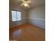 Bright bedroom featuring a ceiling fan, neutral walls, and a large window at 238 W Marco Polo Rd, Phoenix, AZ 85027
