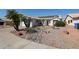 Charming single-story home with desert landscaping and solar panels on the roof at 238 W Marco Polo Rd, Phoenix, AZ 85027
