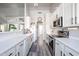 Bright kitchen featuring white cabinets, sleek appliances, and durable quartz countertops at 238 W Marco Polo Rd, Phoenix, AZ 85027