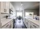 Open kitchen design with white cabinets, stainless steel appliances, and a view into the adjacent dining area at 238 W Marco Polo Rd, Phoenix, AZ 85027