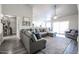 Bright living room with gray sectional, ceiling fan and decorative rug at 238 W Marco Polo Rd, Phoenix, AZ 85027