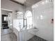 Stunning bathroom featuring a glass shower enclosure and separate soaking tub under arched window at 238 W Marco Polo Rd, Phoenix, AZ 85027