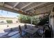 Covered patio with outdoor dining set, ceiling fan, and view of the landscaped backyard at 238 W Marco Polo Rd, Phoenix, AZ 85027