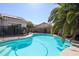 Backyard featuring a refreshing pool with a safety fence surrounded by mature landscaping at 238 W Marco Polo Rd, Phoenix, AZ 85027