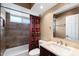 Well-maintained bathroom with a shower-tub combination and vanity with sink and tile backsplash at 2461 Leisure World --, Mesa, AZ 85206