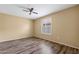 Inviting bedroom boasts wood-style flooring, a window with plantation shutters and neutral color palette at 2461 Leisure World --, Mesa, AZ 85206