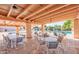 An open-air community area with tables and chairs, ceiling fans, and a view of the community pool at 2461 Leisure World --, Mesa, AZ 85206