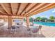An open-air community area with tables and chairs, ceiling fans, and a view of the community pool at 2461 Leisure World --, Mesa, AZ 85206