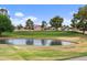 Beautiful golf course view with a tranquil pond and lush greenery at 2461 Leisure World --, Mesa, AZ 85206