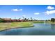 Scenic view of a golf course featuring a water hazard with a fountain, green, and blue skies at 2461 Leisure World --, Mesa, AZ 85206