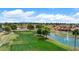 Scenic view of a golf course featuring a water hazard with a fountain, green and blue skies at 2461 Leisure World --, Mesa, AZ 85206