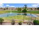 Scenic view of a golf course featuring a water hazard with a fountain and a clear blue sky at 2461 Leisure World --, Mesa, AZ 85206