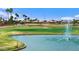 Scenic view of a golf course featuring a water hazard with a fountain and surrounding homes at 2461 Leisure World --, Mesa, AZ 85206