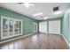 Airy living room featuring wood flooring, ceiling fans, dual windows and dual closets for ample storage at 2461 Leisure World --, Mesa, AZ 85206