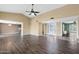 Open-concept living room with tile and wood floors and a view into the kitchen and entry at 2461 Leisure World --, Mesa, AZ 85206