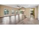 Spacious living room featuring wood floors, high ceilings, and natural light from large windows at 2461 Leisure World --, Mesa, AZ 85206