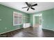 Bright living room featuring wood-style tile flooring, a ceiling fan, and an open doorway at 2461 Leisure World --, Mesa, AZ 85206