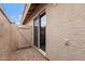 Cozy outdoor patio area with sliding glass door and gate access, offering privacy and natural light at 2461 Leisure World --, Mesa, AZ 85206