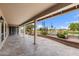 Expansive covered patio with travertine flooring overlooks lush golf course views at 2461 Leisure World --, Mesa, AZ 85206