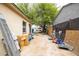 Enclosed backyard with large tree offering shade and mature plants at 2542 W Missouri Ave, Phoenix, AZ 85017