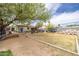 Wide-open backyard with some grass, a large pile of rocks, and a storage trailer at 2542 W Missouri Ave, Phoenix, AZ 85017