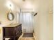 Small bathroom featuring a single sink vanity and tiled shower with curtain at 2542 W Missouri Ave, Phoenix, AZ 85017