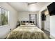 Cozy bedroom with hardwood floors, closet, and large windows providing lots of natural light at 2542 W Missouri Ave, Phoenix, AZ 85017