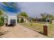 House featuring a well-manicured lawn, mature trees, and a 'Just Listed' sign showcasing curb appeal at 2542 W Missouri Ave, Phoenix, AZ 85017