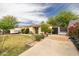 Quaint house with desert landscaping, a well-manicured lawn, and mature trees offering curb appeal at 2542 W Missouri Ave, Phoenix, AZ 85017