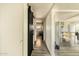 Hallway with light wood floors, white walls, and a modern sliding barn door at 2542 W Missouri Ave, Phoenix, AZ 85017