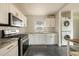 White kitchen cabinets, granite countertops, stainless steel appliances and subway tile backsplash at 2542 W Missouri Ave, Phoenix, AZ 85017