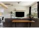 Bright living room with floating wood shelf, large screen TV and a cozy gray sectional at 2542 W Missouri Ave, Phoenix, AZ 85017