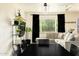Bright living area with neutral furnishings, black curtains and large window at 2542 W Missouri Ave, Phoenix, AZ 85017