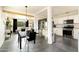 Open concept living spaces flow together, featuring black dining set, neutral sofa and a crisp, white kitchen with subway tile at 2542 W Missouri Ave, Phoenix, AZ 85017