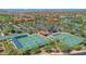 Aerial view of the community with tennis and pickleball courts, desert landscaping, and scenic community buildings at 2885 N 164Th Dr, Goodyear, AZ 85395