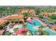 Aerial view of the community pool area, showcasing multiple pools, lounge areas, and desert landscaping at 2885 N 164Th Dr, Goodyear, AZ 85395