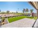 Beautiful backyard with artificial grass, paved patio, and view of the golf course at 2885 N 164Th Dr, Goodyear, AZ 85395
