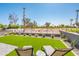 Lounge chairs on artificial grass with a view of desert landscape and palm trees at 2885 N 164Th Dr, Goodyear, AZ 85395