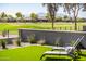 Relaxing backyard featuring artificial turf, lounge chairs, and a view of the well-maintained golf course at 2885 N 164Th Dr, Goodyear, AZ 85395