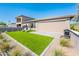 Backyard with artificial grass, paved patio, and retractable shades at 2885 N 164Th Dr, Goodyear, AZ 85395