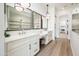 Bathroom features dual vanities, framed mirrors, and modern lighting fixtures at 2885 N 164Th Dr, Goodyear, AZ 85395