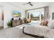 Cozy bedroom boasts a large window, stylish furnishings and a comfortable king-sized bed at 2885 N 164Th Dr, Goodyear, AZ 85395