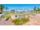 Welcome to PebbleCreek sign surrounded by beautiful landscaping, ponds, and scenic views of the community at 2885 N 164Th Dr, Goodyear, AZ 85395