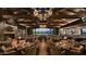Elegant dining room boasts stone fireplace, wood beamed ceilings, and golf course views at 2885 N 164Th Dr, Goodyear, AZ 85395