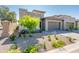 Lovely single-Gathering house with manicured desert landscaping and a modern gray garage door at 2885 N 164Th Dr, Goodyear, AZ 85395