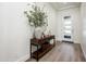 Bright and airy entryway featuring wood floors, a wood console table, modern decor, and a door with windows at 2885 N 164Th Dr, Goodyear, AZ 85395