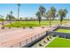 Scenic view of the golf course from the home, featuring lush greenery, mature trees, and well-maintained grounds at 2885 N 164Th Dr, Goodyear, AZ 85395
