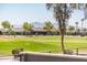 Picturesque golf course view showcasing the manicured green, surrounding residences, and distant mountain views at 2885 N 164Th Dr, Goodyear, AZ 85395
