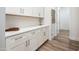 Hallway features built in cabinets with counter space and hardwood flooring at 2885 N 164Th Dr, Goodyear, AZ 85395